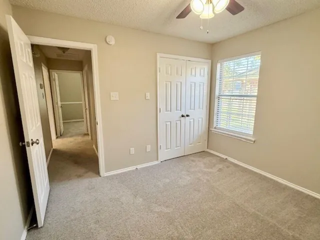 a bathroom with a granite countertop sink a toilet and a shower