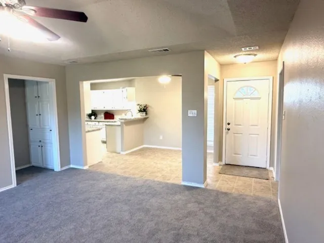 a kitchen with stainless steel appliances granite countertop a sink a refrigerator and a cabinets