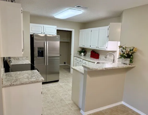 a kitchen with stainless steel appliances a sink stove and refrigerator