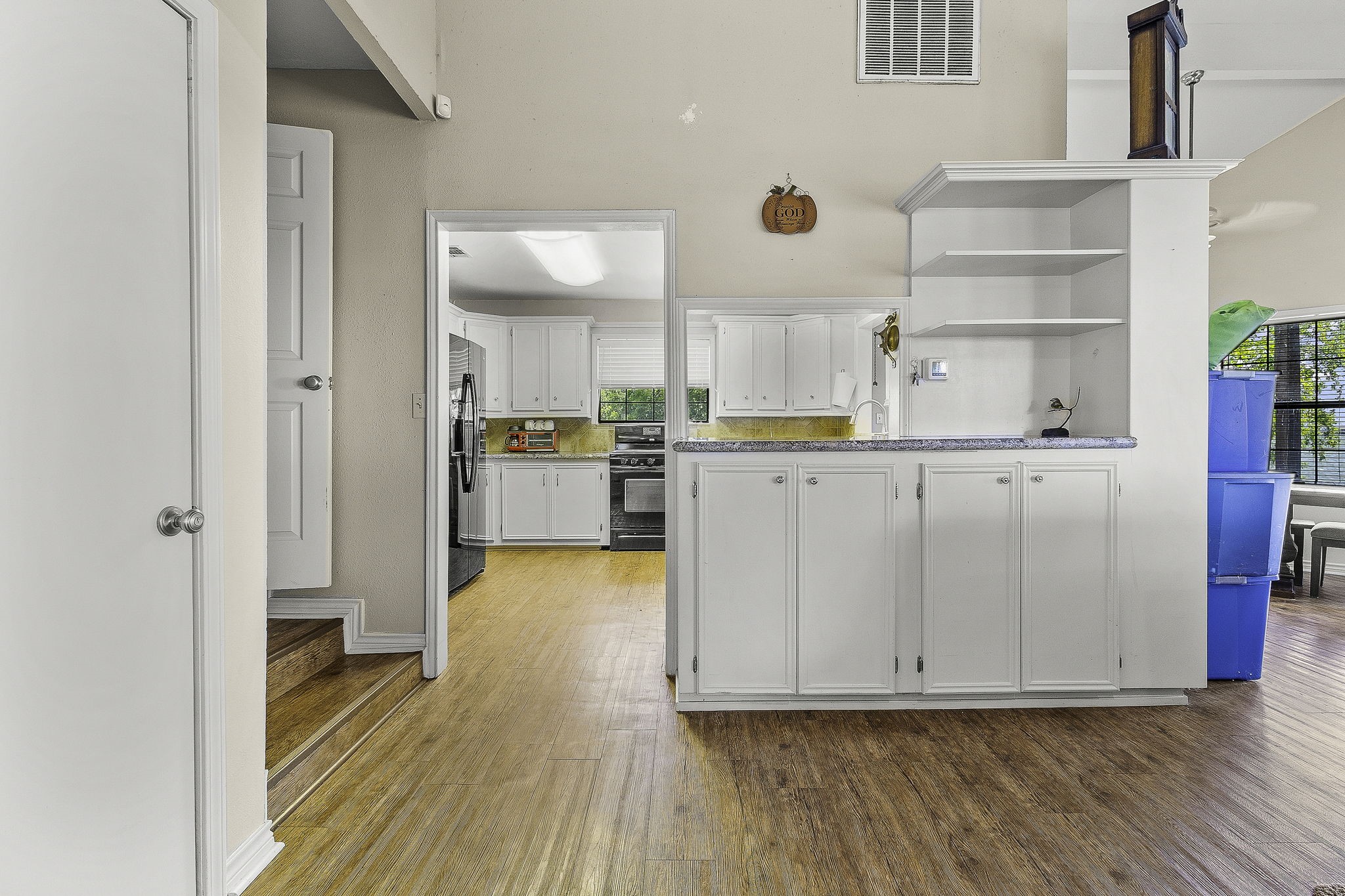 536 Weavers Cove Road Livingston, TX 77351 - Photo 15 of 44 a kitchen with white cabinets and wooden floor