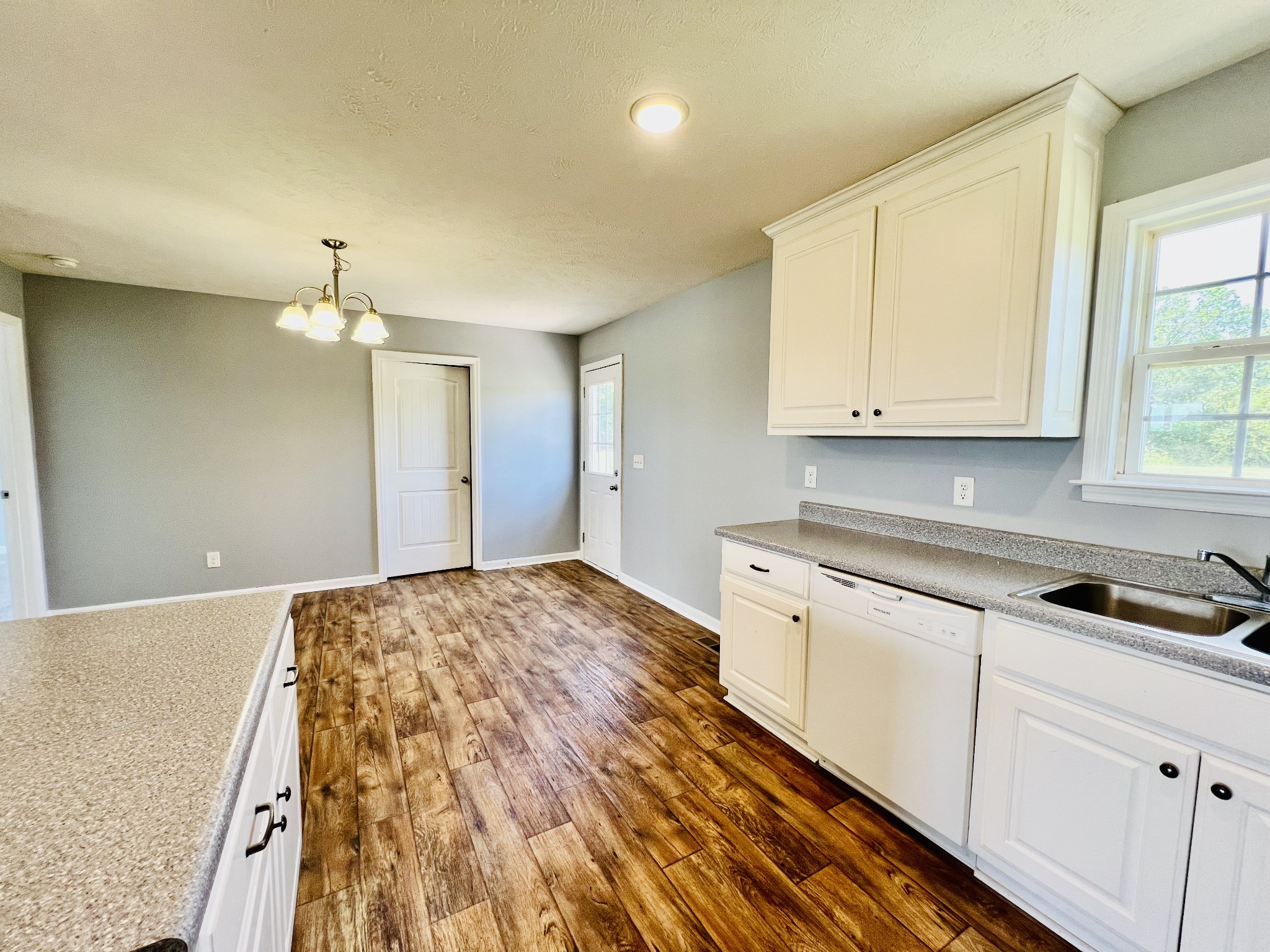 4560 Fall River Road Pulaski, TN 38478 - Photo 11 of 28 a kitchen with granite countertop a sink and cabinets