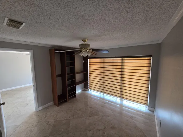 a view of a livingroom with an empty space and a window