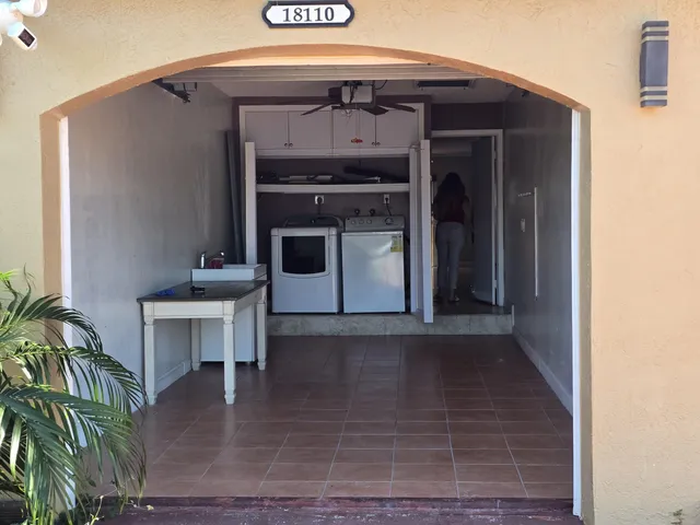 a view of a hallway with wooden floor and a fireplace