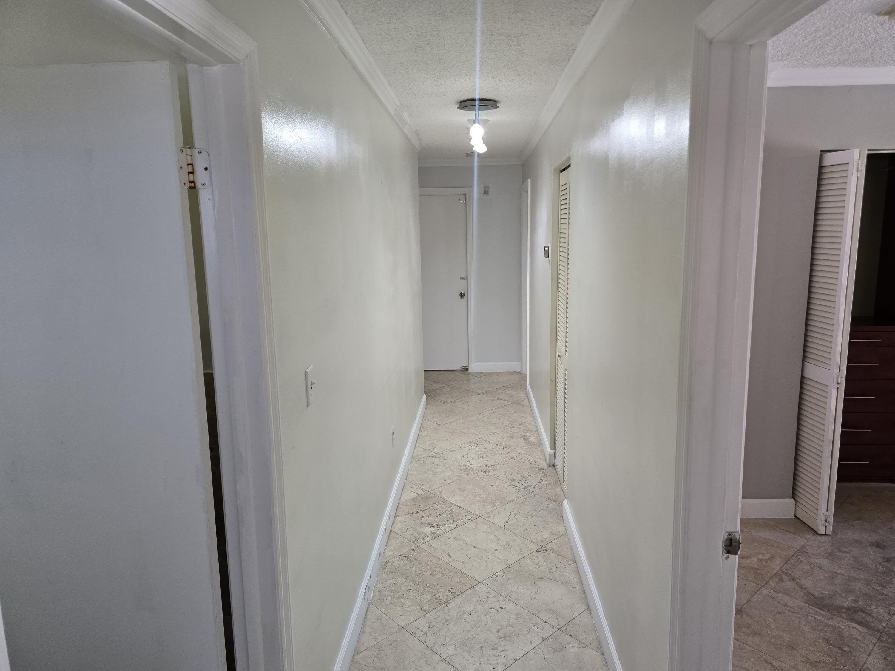 18110 Southwest 139th Court Miami, FL 33177 - Photo 17 of 24 a view of a hallway with wooden floor