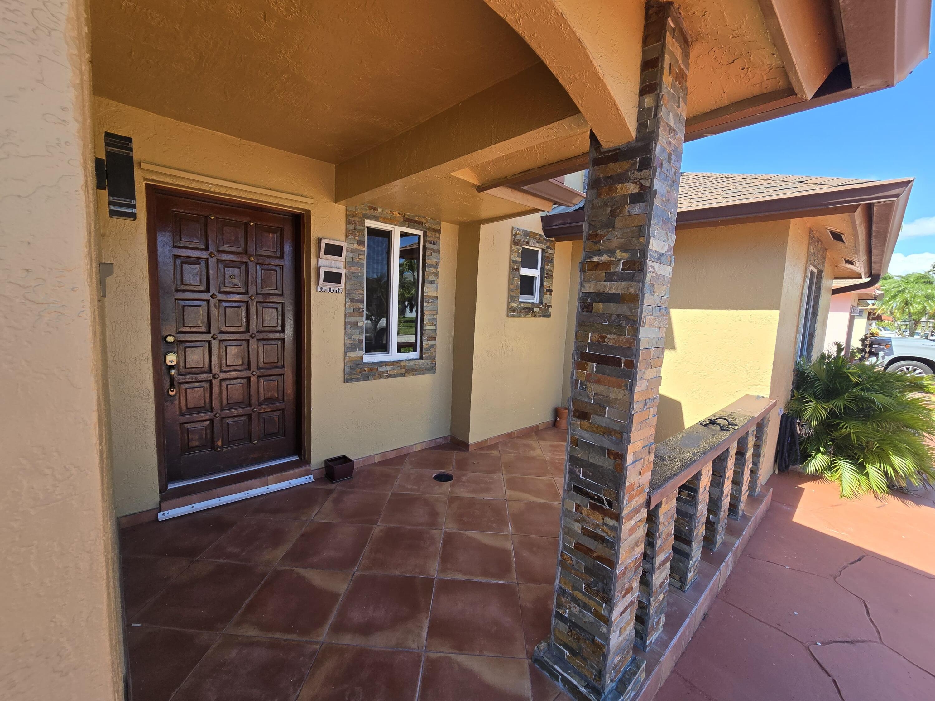 18110 Southwest 139th Court Miami, FL 33177 - Photo 2 of 24 a view of an entryway door