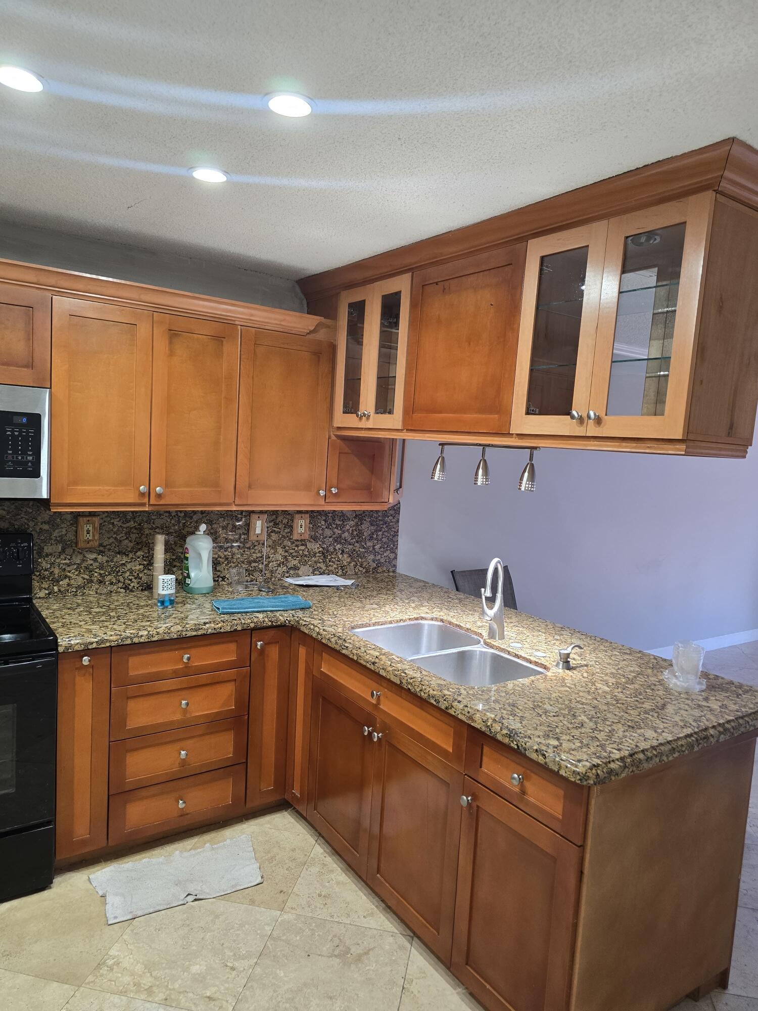18110 Southwest 139th Court Miami, FL 33177 - Photo 6 of 24 a kitchen with a sink and cabinets