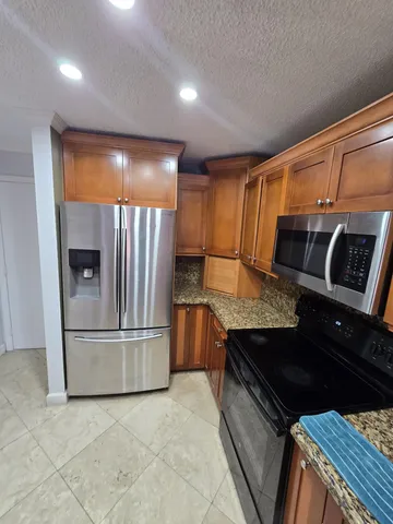 a kitchen with a stove and a refrigerator