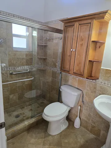 a bathroom with a toilet and a shower