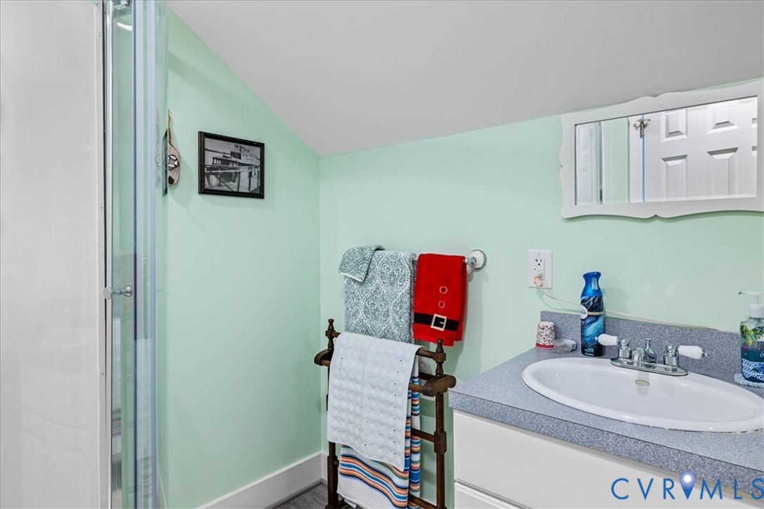 683 Villa Road Claremont, VA 23881 - Photo 26 of 28 a bathroom with a sink and a mirror