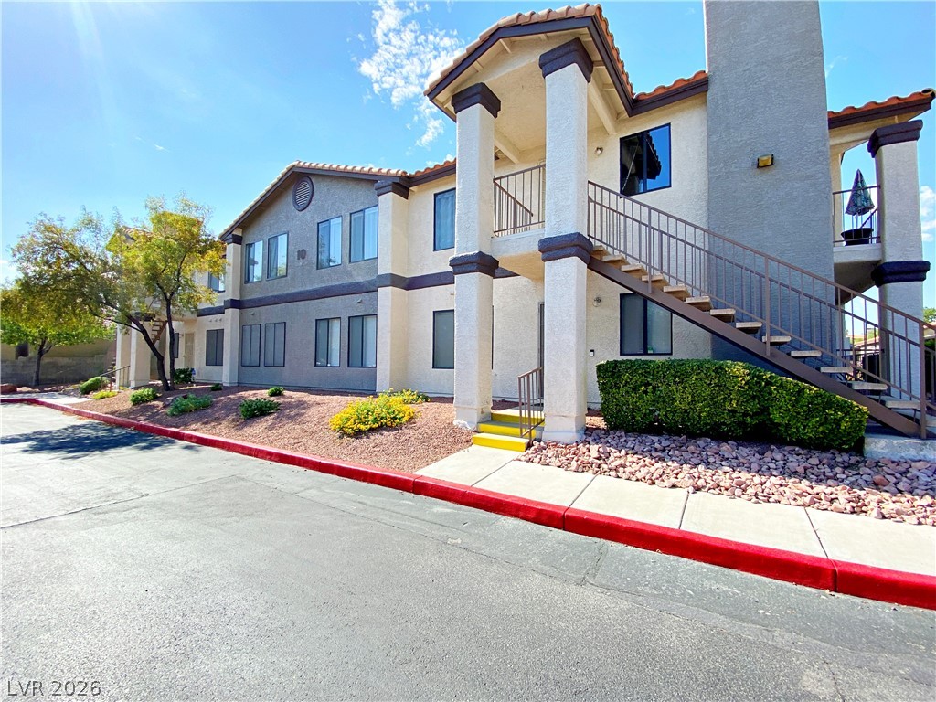 1575 West Warm Springs Road, Unit 1024 Henderson, NV 89014 - Photo 5 of 25 A well-maintained stucco facade with a terracotta tile roof and mature landscaping welcomes residents.