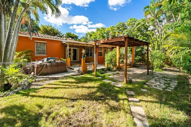 a backyard of a house with barbeque oven table and chairs