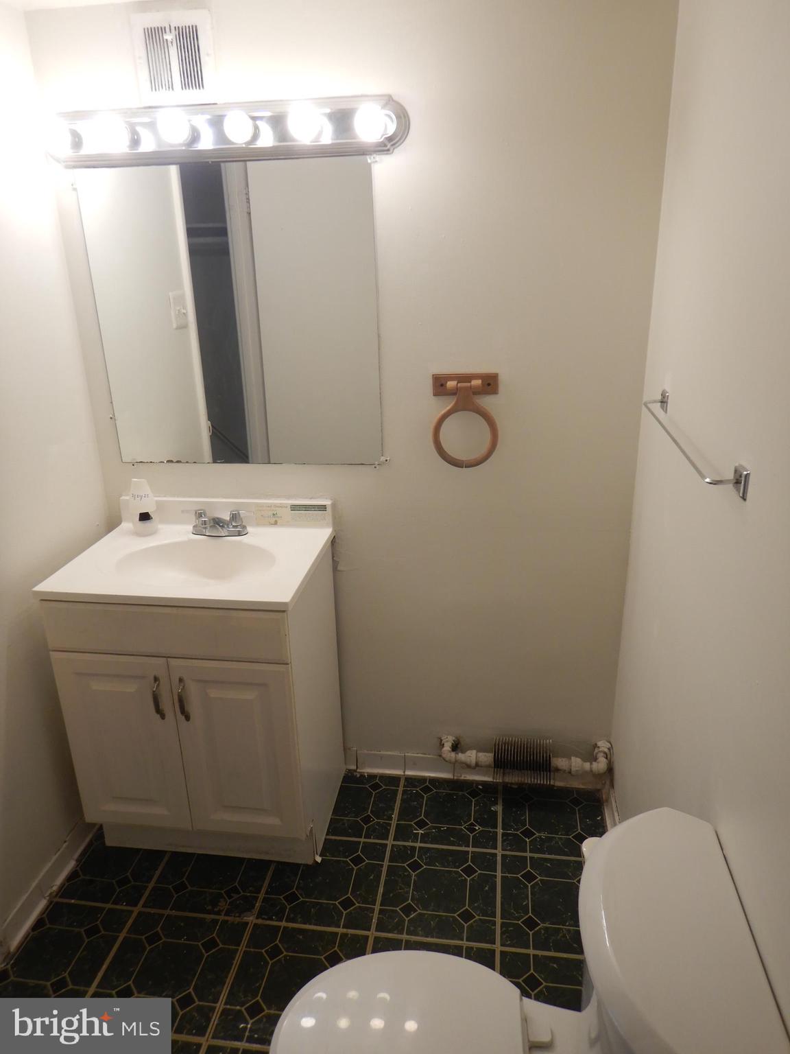 8830 Piney Branch Road, Unit 401 Silver Spring, MD 20903 - Photo 17 of 17 a bathroom with a sink toilet and mirror