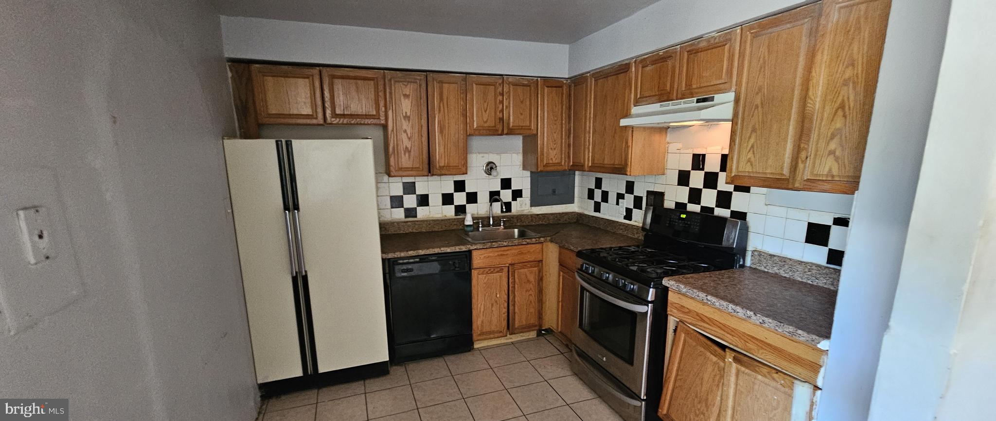 8830 Piney Branch Road, Unit 401 Silver Spring, MD 20903 - Photo 10 of 17 a kitchen with stainless steel appliances a refrigerator stove and sink
