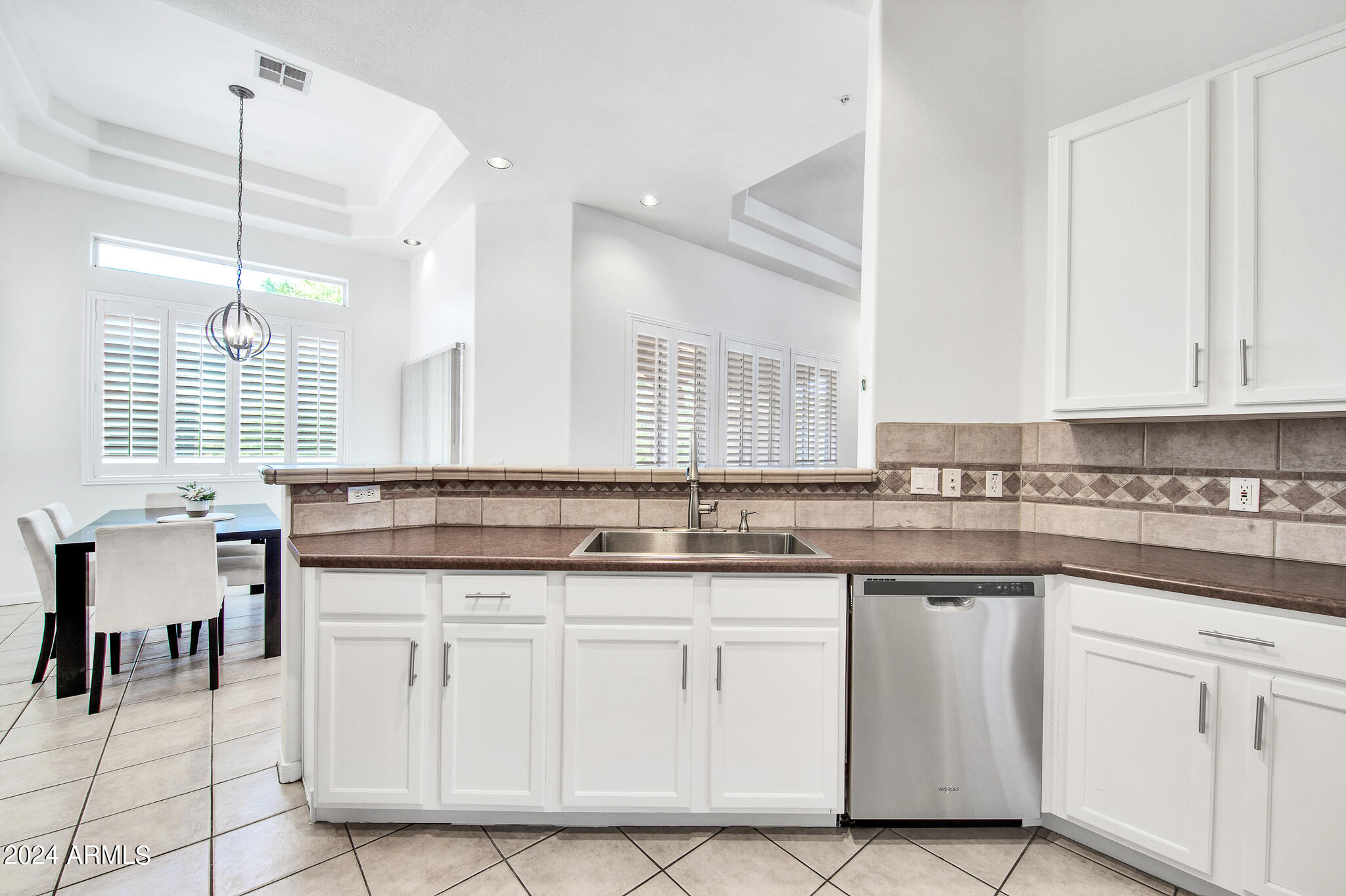 8245 East Bell Road, Unit 209 Scottsdale, AZ 85260 - Photo 15 of 49 a kitchen with white cabinets and sink
