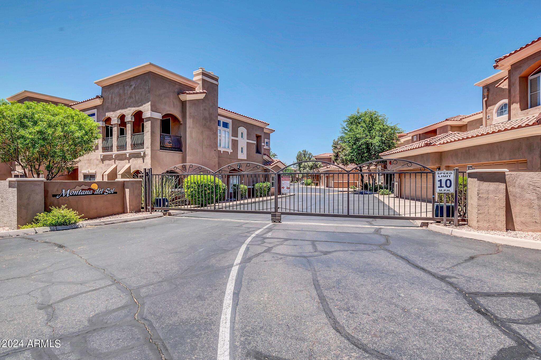 8245 East Bell Road, Unit 209 Scottsdale, AZ 85260 - Photo 2 of 49 a front view of a house with garden