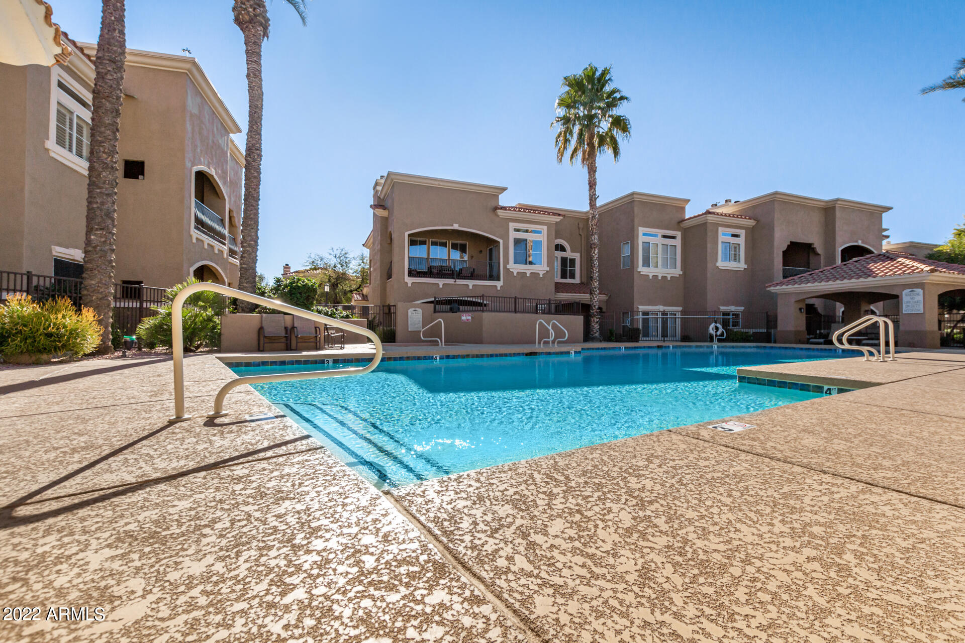 8245 East Bell Road, Unit 209 Scottsdale, AZ 85260 - Photo 44 of 49 a front view of a house with a yard