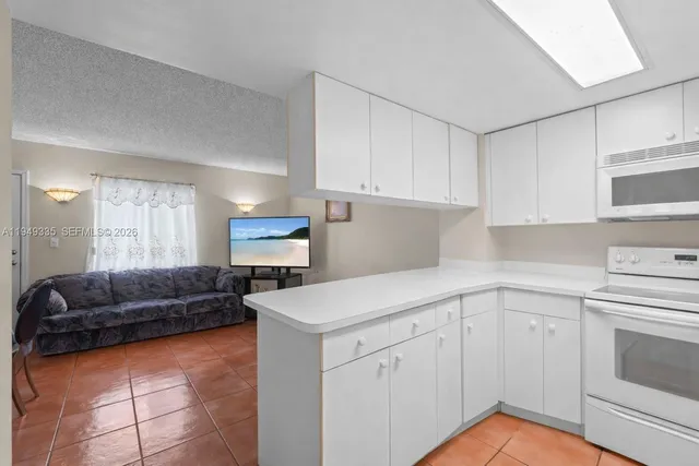 a kitchen with cabinets and window