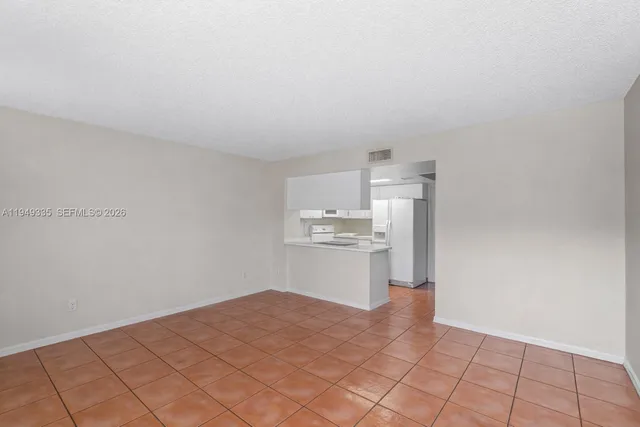 a kitchen with a sink cabinets and wooden floor