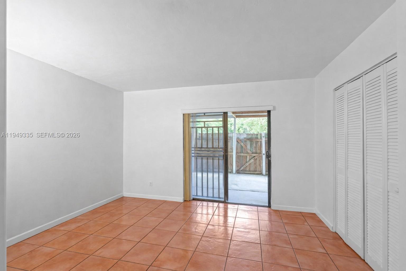 2178 West 60th Street, Unit 18111 Hialeah, FL 33016 - Photo 5 of 17 a view of an empty room with wooden floor