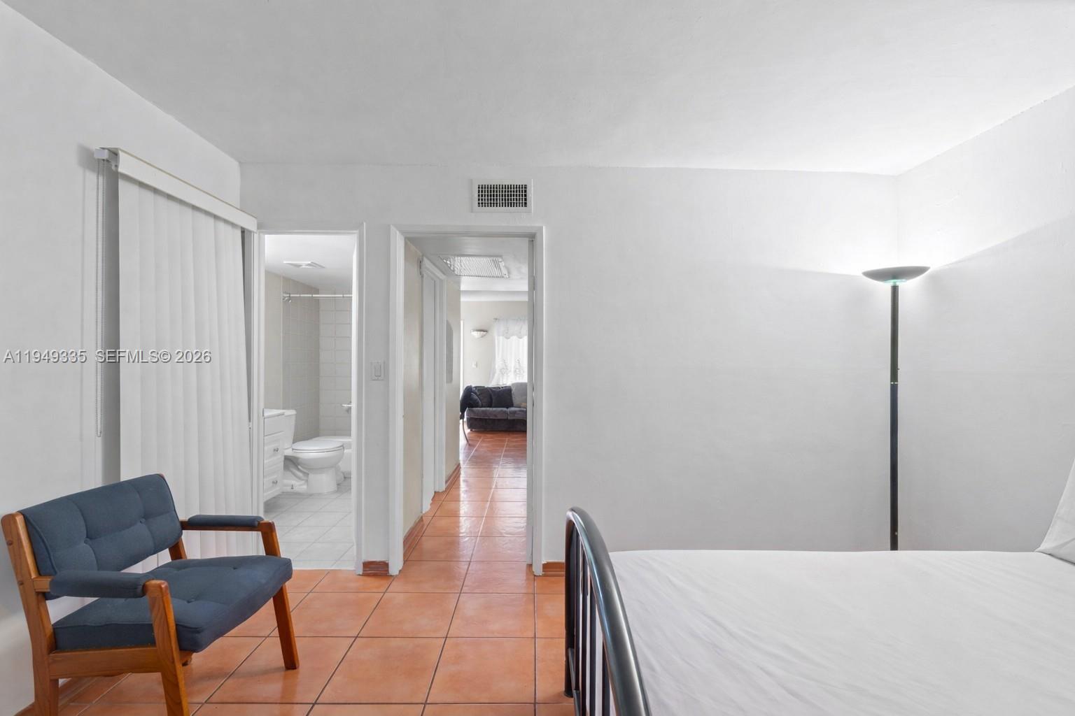 2178 West 60th Street, Unit 18111 Hialeah, FL 33016 - Photo 6 of 17 a bedroom with a bed and chair