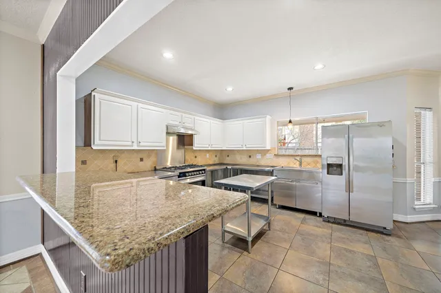 a kitchen with stainless steel appliances granite countertop a sink counter space and cabinets