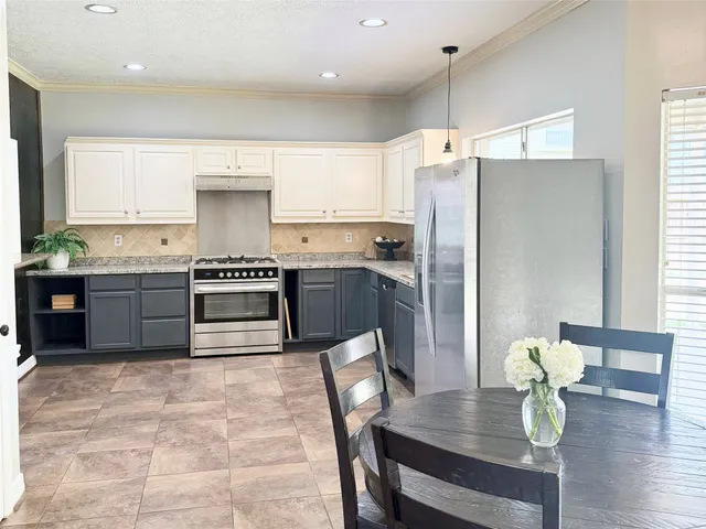 a kitchen with lots of counter top space and dining table