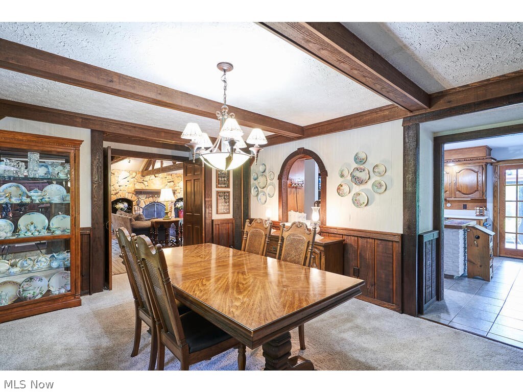 3376 West Bath Road Akron, OH 44333 - Photo 5 of 49 Dining room featuring beamed ceiling, carpet, an inviting chandelier