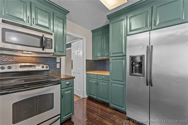 a kitchen with cabinets and stainless steel appliances