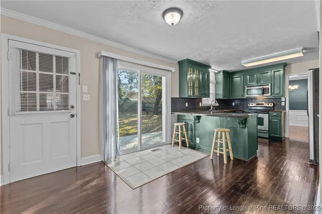 a dining room with furniture and wooden floor