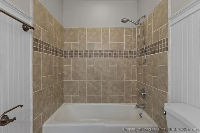 a bathroom with a shower and a toilet