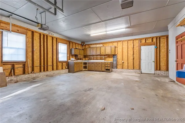 a view of a house with a large tree and a yard