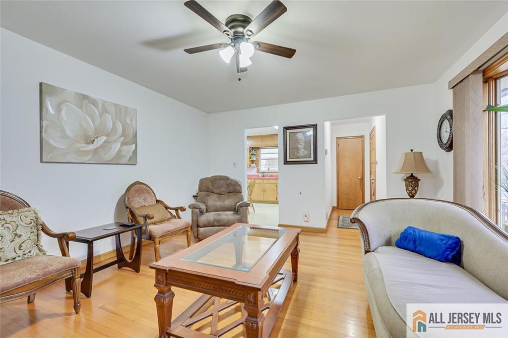 26 Goodwill Place Metuchen, NJ 08840 - Photo 11 of 34 a living room with furniture and a chandelier