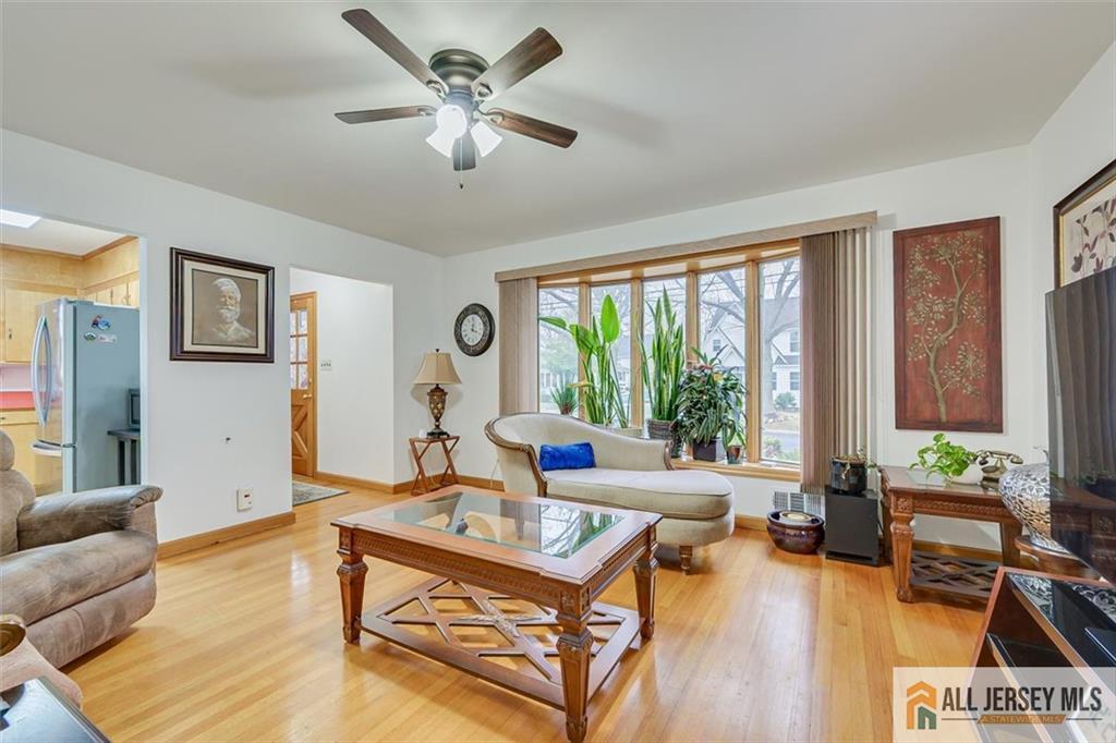 26 Goodwill Place Metuchen, NJ 08840 - Photo 12 of 34 a living room with furniture a table and a large window