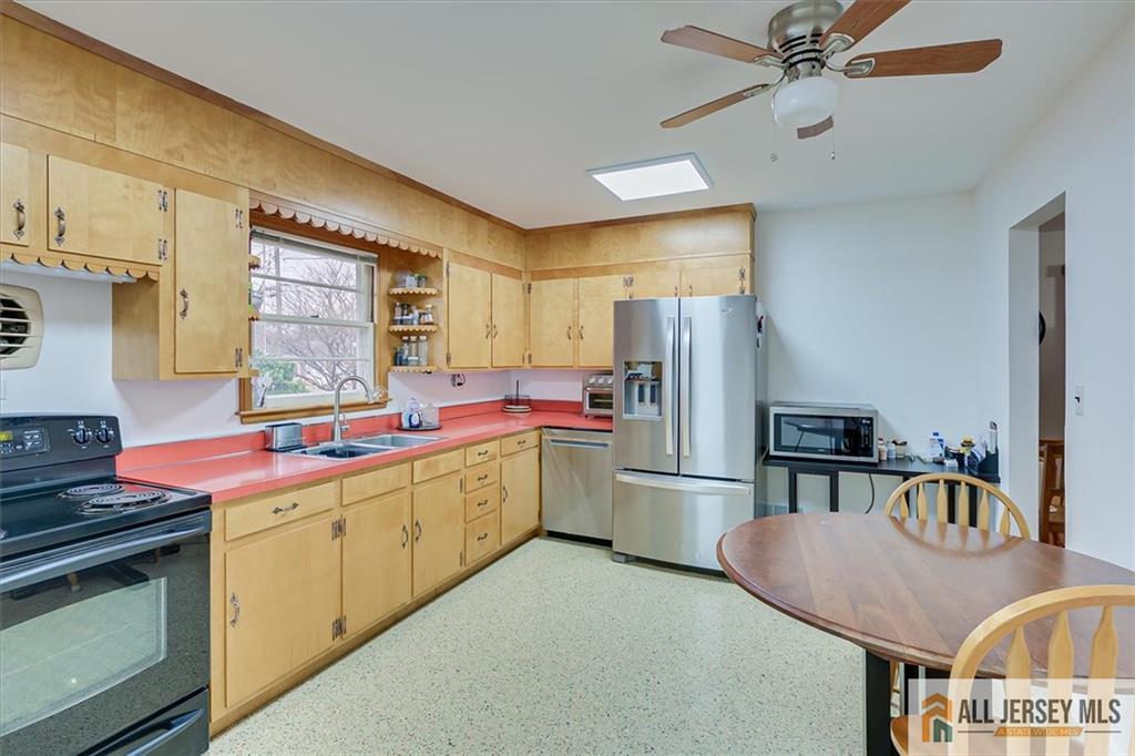 26 Goodwill Place Metuchen, NJ 08840 - Photo 16 of 34 a kitchen that has a lot of cabinets and refrigerator in it