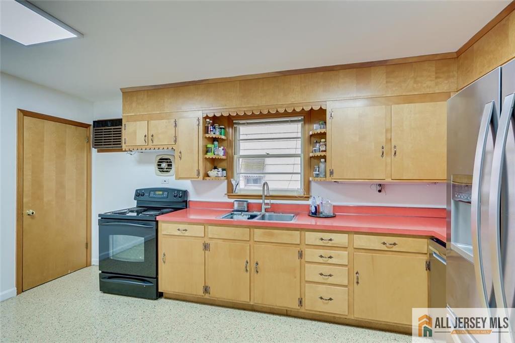 26 Goodwill Place Metuchen, NJ 08840 - Photo 17 of 34 a kitchen with a sink stove and cabinets