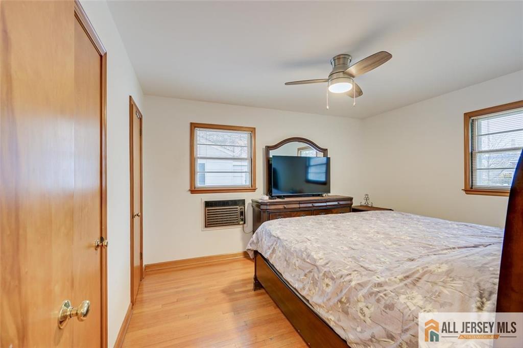 26 Goodwill Place Metuchen, NJ 08840 - Photo 18 of 34 a bedroom with a large bed and a tv