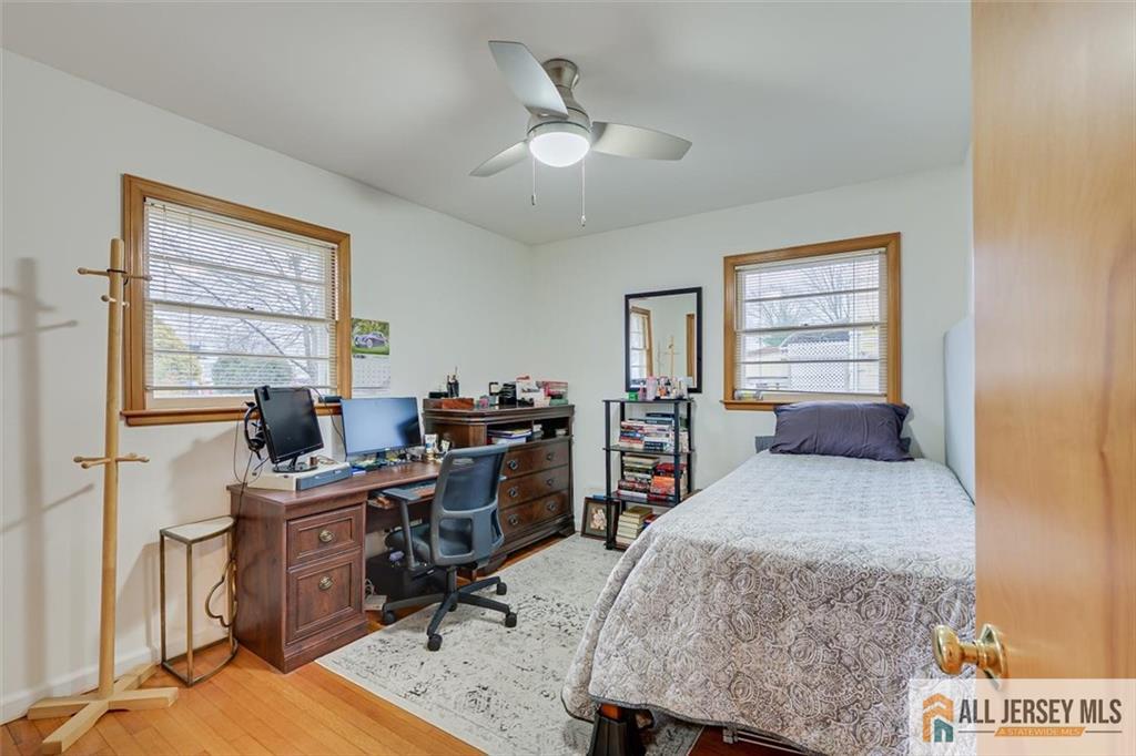 26 Goodwill Place Metuchen, NJ 08840 - Photo 22 of 34 a bedroom with a bed a desk chair and windows