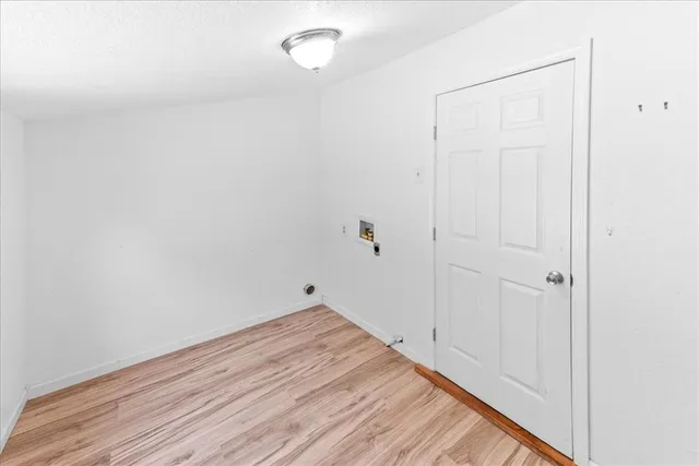 a view of a room with wooden floor