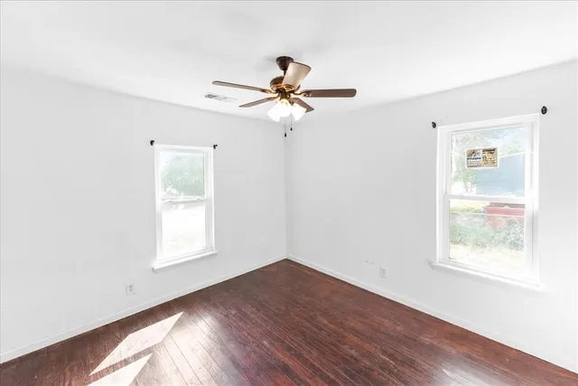 wooden floor in an empty room with a window