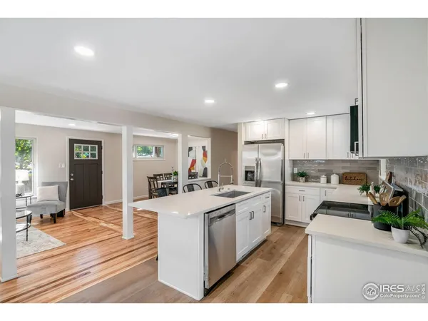 a kitchen with a stove a refrigerator and a sink