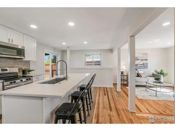 a open kitchen with stainless steel appliances kitchen island granite countertop a sink and cabinets
