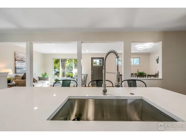 a kitchen with a sink and a large mirror