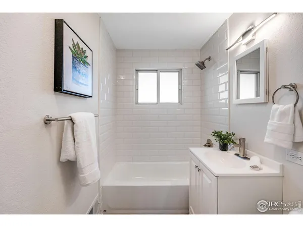 a bathroom with a sink a bathtub and a mirror