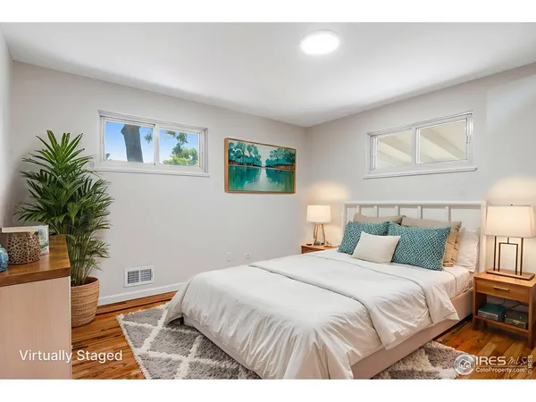 a bedroom with a bed and a potted plant
