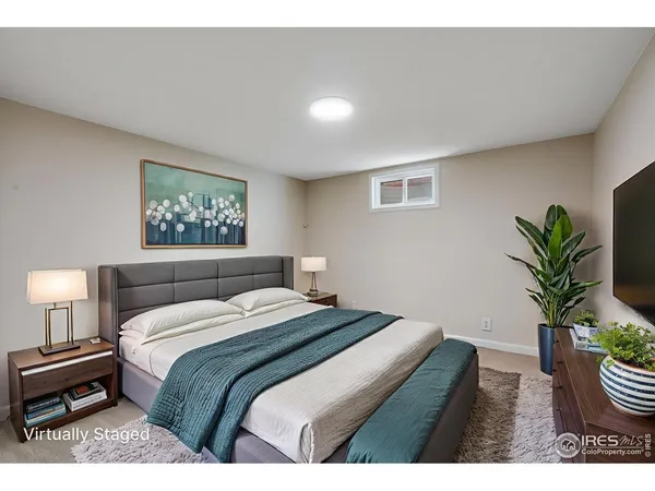 a bedroom with a bed and a potted plant
