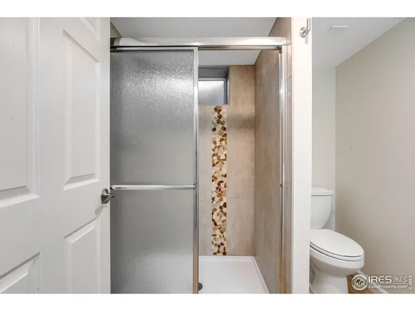 a bathroom with a shower and a toilet