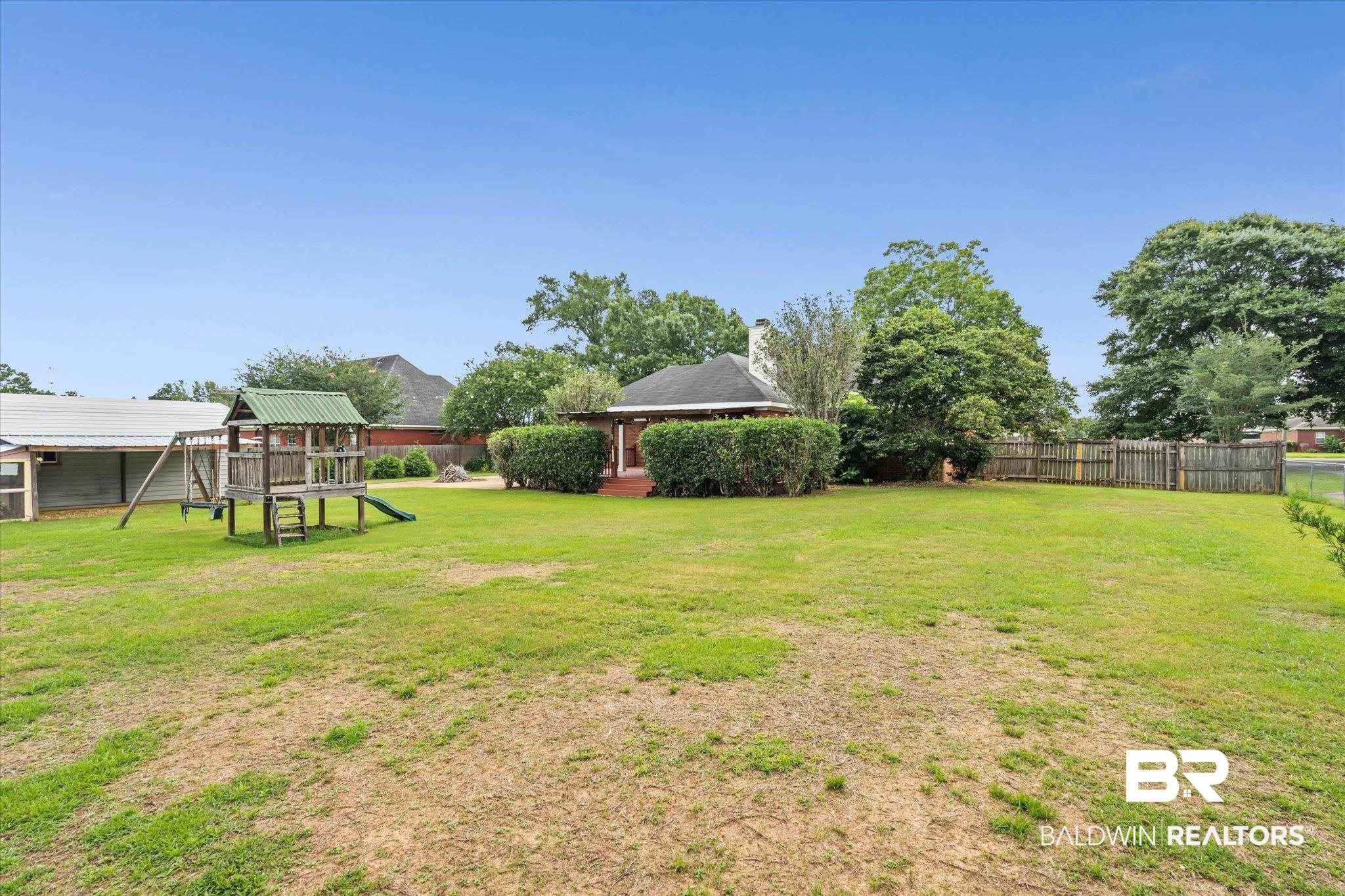 3170 Scott Dairy Loop Road West Mobile, AL 36695 - Photo 21 of 24 Expansive backyard featuring a large green space, mature trees, and a wooden privacy fence