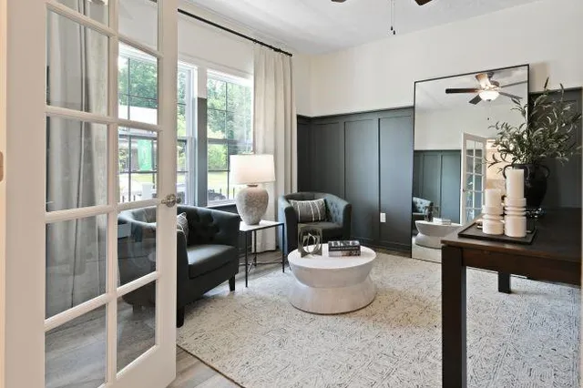 a living room with furniture a fireplace and a flat screen tv