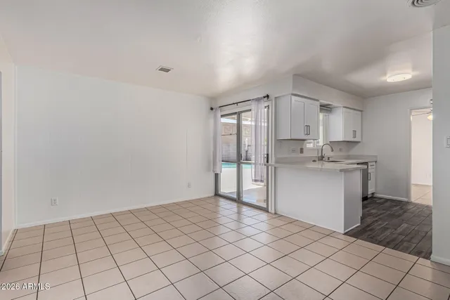 a view of a kitchen with a refrigerator and a sink