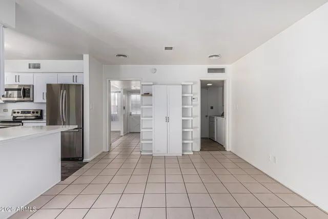 a kitchen with stainless steel appliances granite countertop a refrigerator sink and stove